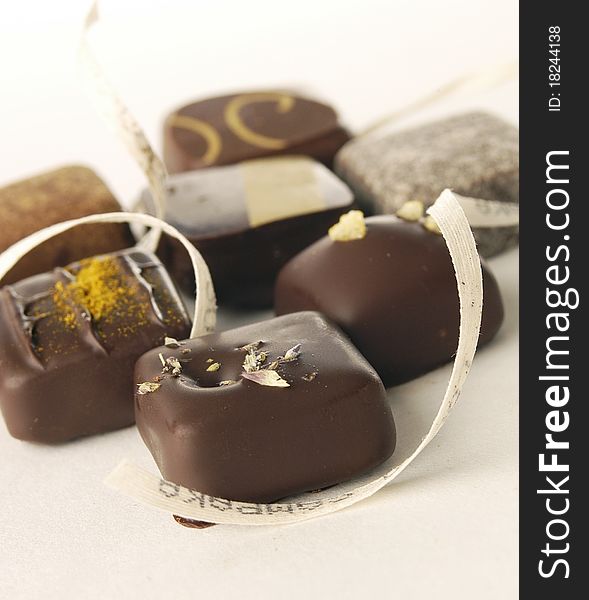 Delicious luxurious chocolate bonbons on light background. Delicious luxurious chocolate bonbons on light background