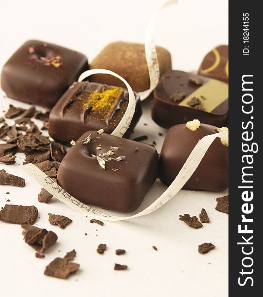 Delicious luxurious chocolate bonbons on light background. Delicious luxurious chocolate bonbons on light background