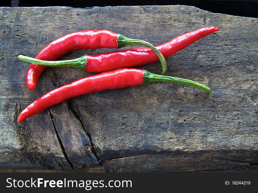 Chilli Peppers on aged wood