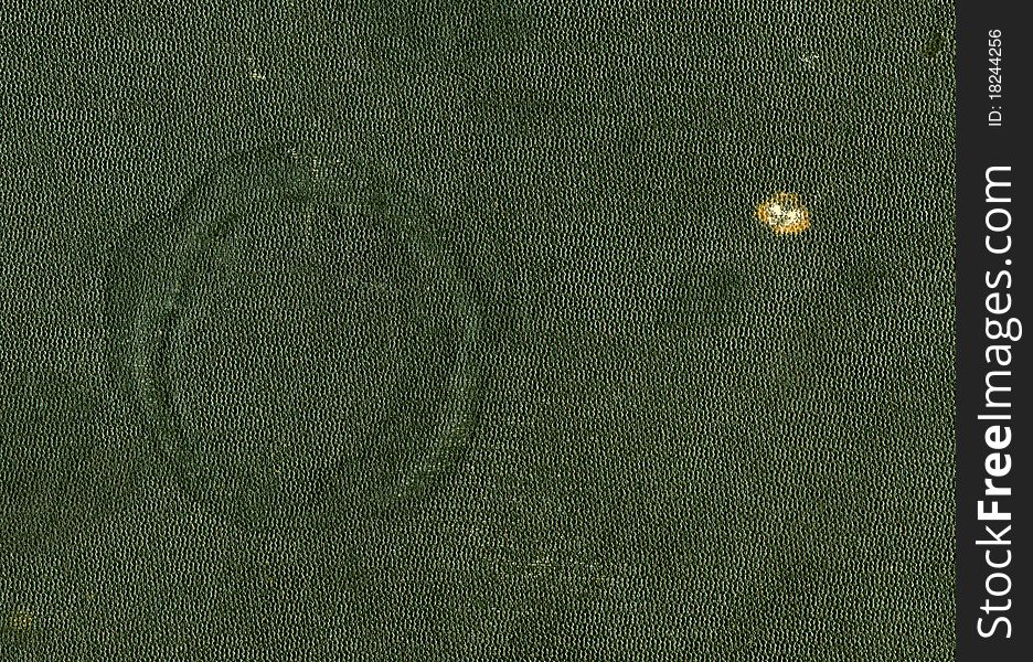 Green leather cover of an antique book with a trace of a hot cup