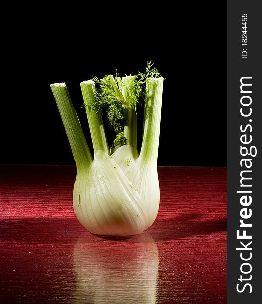 Photo of fennel on red glasstable