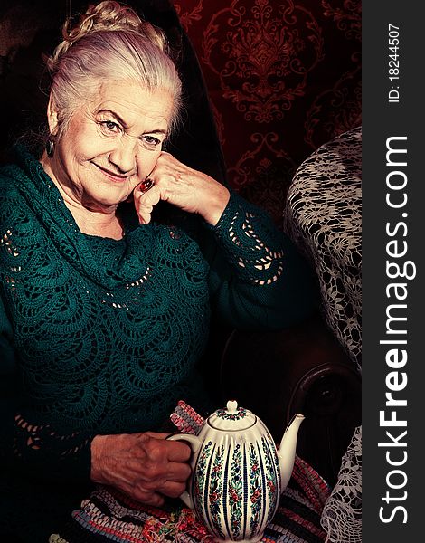 Portrait of a smiling senior woman having a rest at home. Portrait of a smiling senior woman having a rest at home.