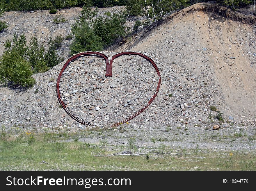Metal heart formed on country hillside. Metal heart formed on country hillside