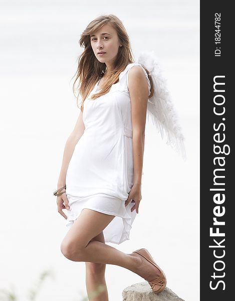 Young Brunette Girl with angel wings