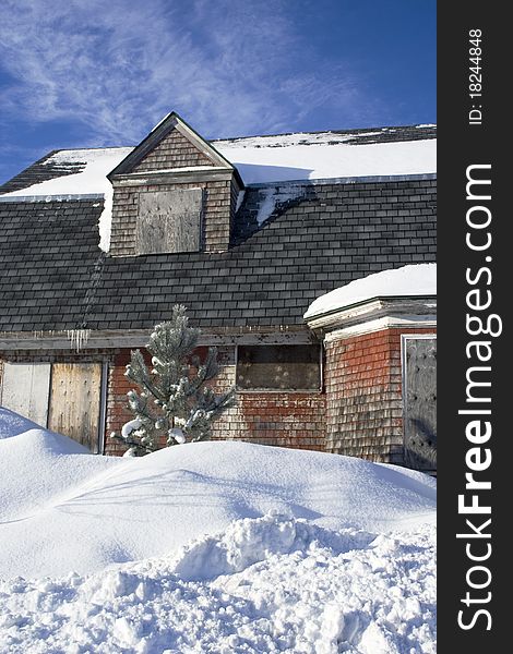 Abandoned house with snow and blue sky. Abandoned house with snow and blue sky