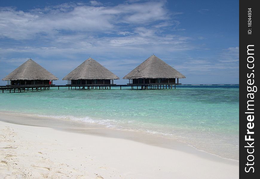 Tropical maldivian beach with turquoise water and white coral sand. Tropical maldivian beach with turquoise water and white coral sand