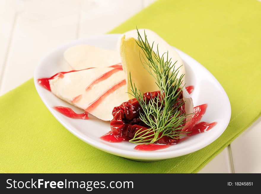 Mozzarella cheese with garnish and raspberry balsamic reduction. Mozzarella cheese with garnish and raspberry balsamic reduction
