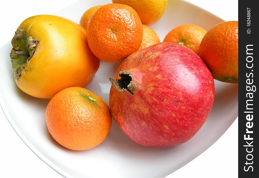 Fruits on plates isolated on white studio background.