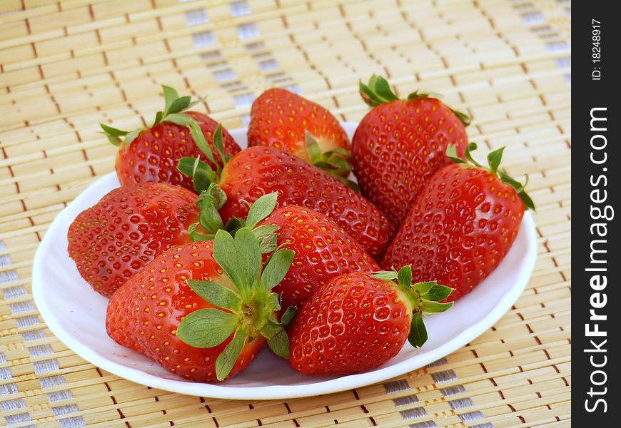 Appetizing large strawberry on a white plate