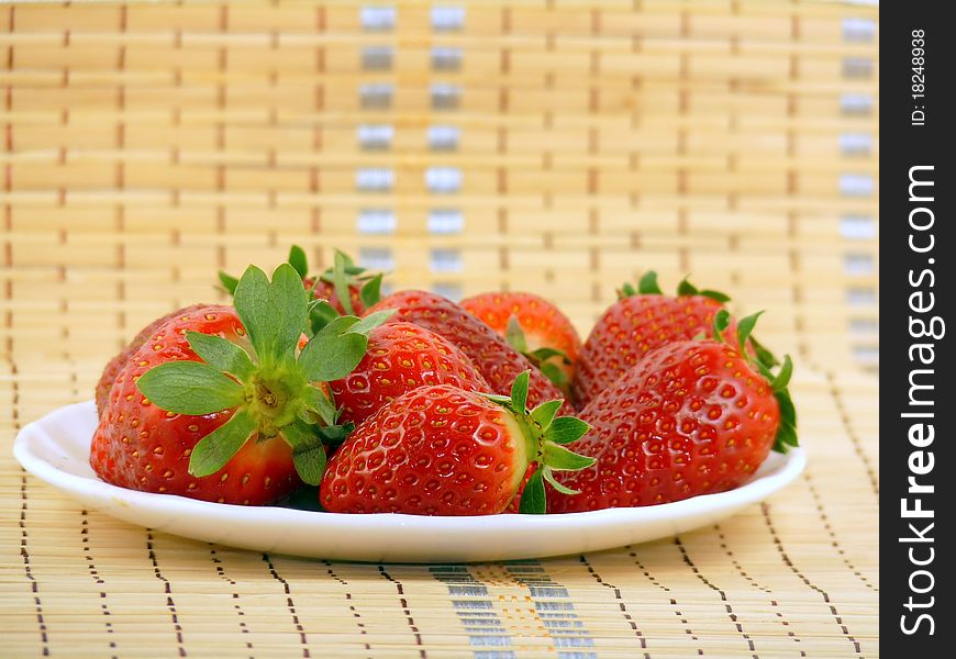 Appetizing large strawberry on a white plate
