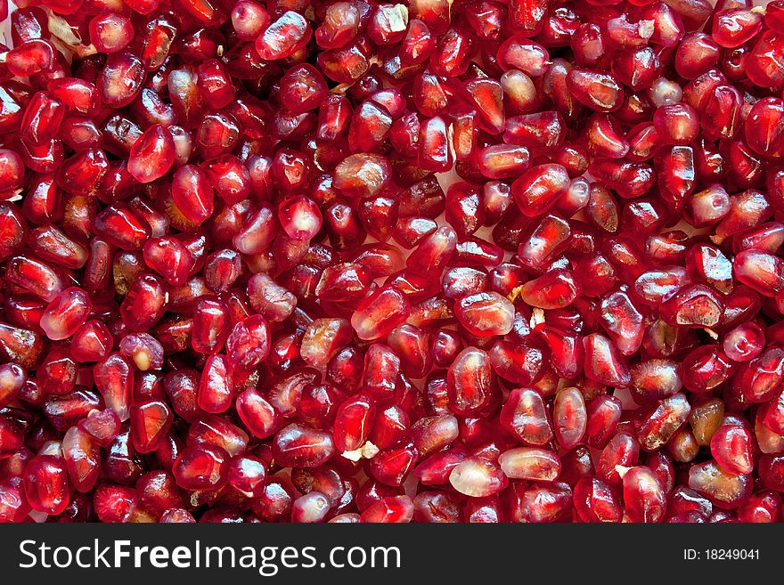 Red ripe grains of pomegranate background