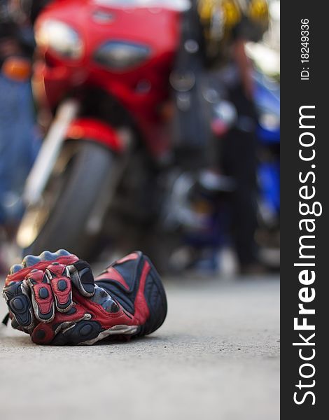 Motorcycle Gloves against a motorcycle abstract sport