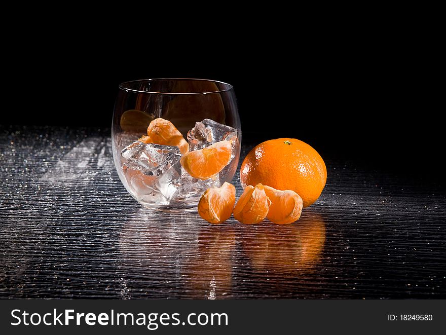 Photo of delicious orange mandarins on ice cubes. Photo of delicious orange mandarins on ice cubes