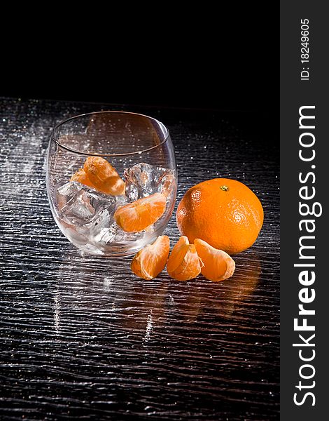 Photo of delicious orange mandarins on ice cubes. Photo of delicious orange mandarins on ice cubes