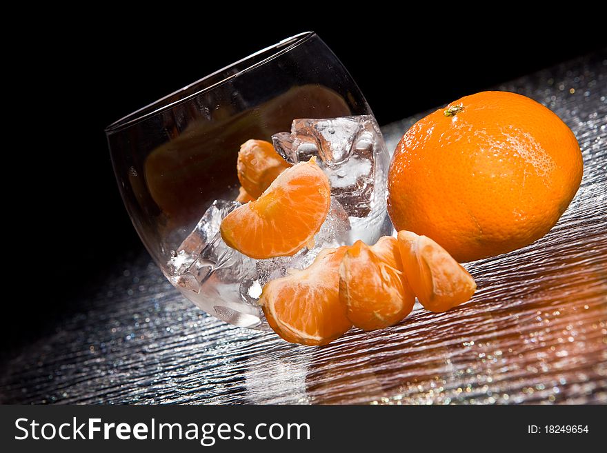 Photo of delicious orange mandarins on ice cubes. Photo of delicious orange mandarins on ice cubes