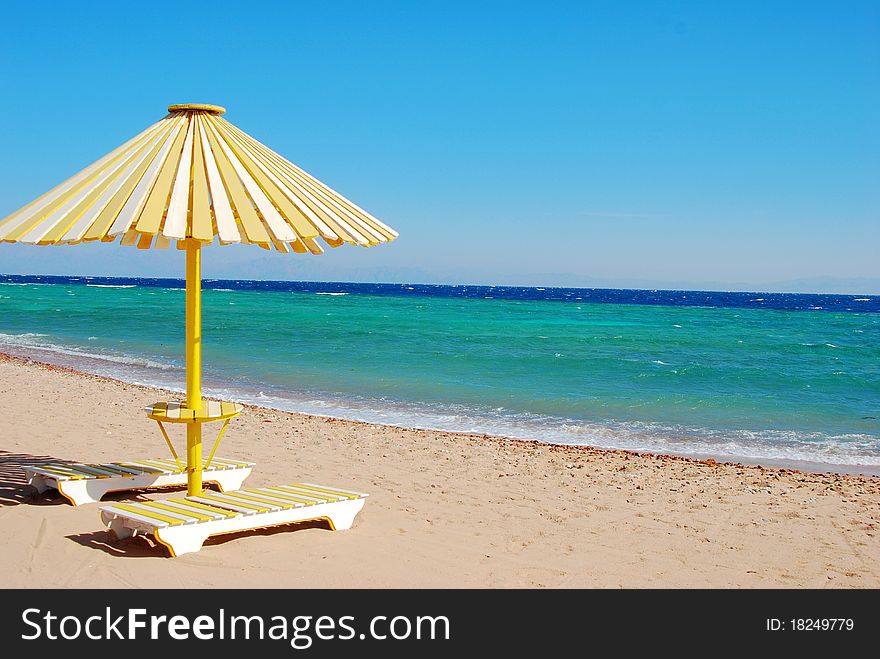 The white-yellow beach sun umbrella