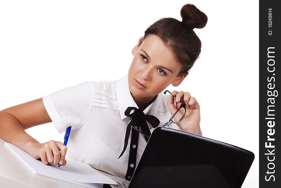 Young Woman Sitting At A Table Taking Notes