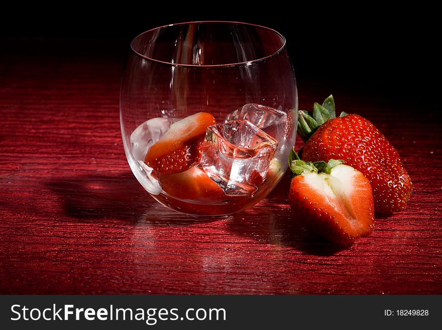 Strawberries On Ice On Red Background