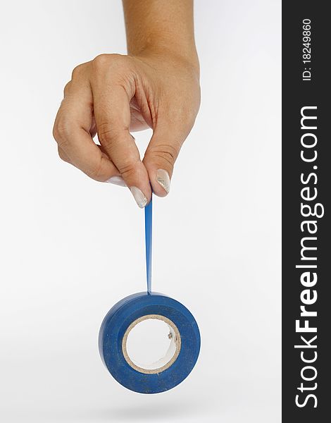 Isolate of a woman's hand holding the blue tape on a white background