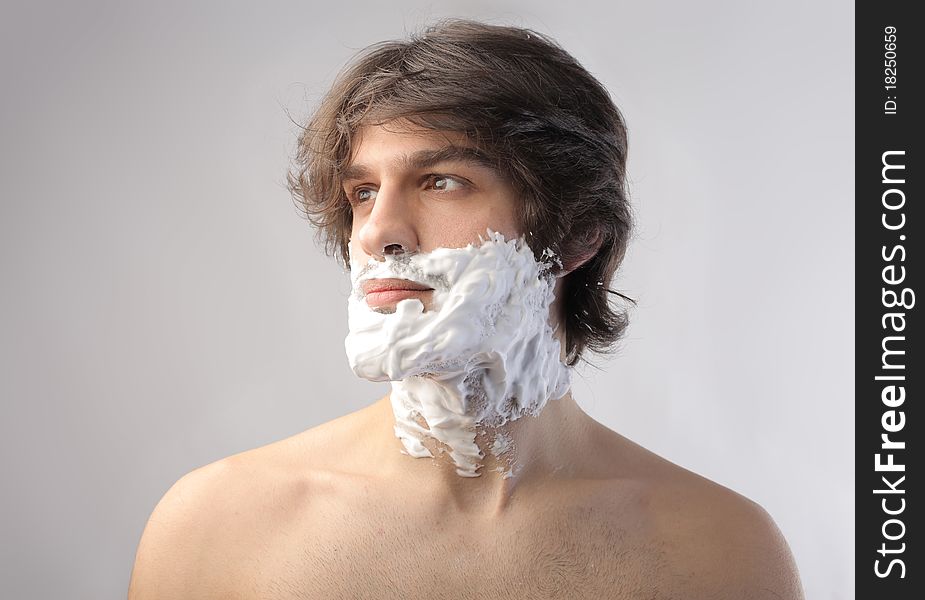 Young man with shaving cream on his face. Young man with shaving cream on his face