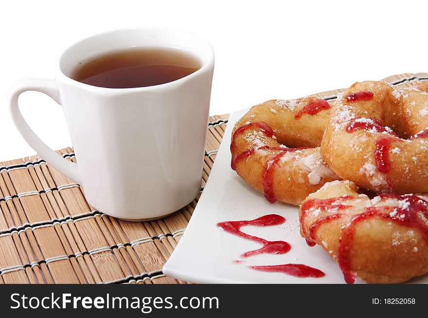 Donuts with jam and a cup of tea. Donuts with jam and a cup of tea