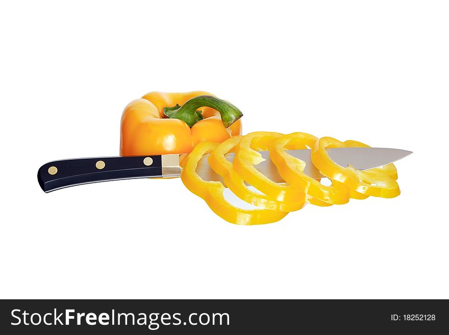 Kitchen knife cutting yellow sweet pepper. Isolated on white with clipping path. Kitchen knife cutting yellow sweet pepper. Isolated on white with clipping path