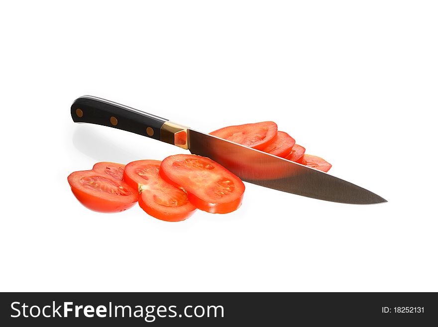 Kitchen knife cutting tomato. Icolated on white with clipping path. Kitchen knife cutting tomato. Icolated on white with clipping path