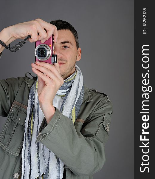 Young man with digital photo camera. isolated on white background. Young man with digital photo camera. isolated on white background
