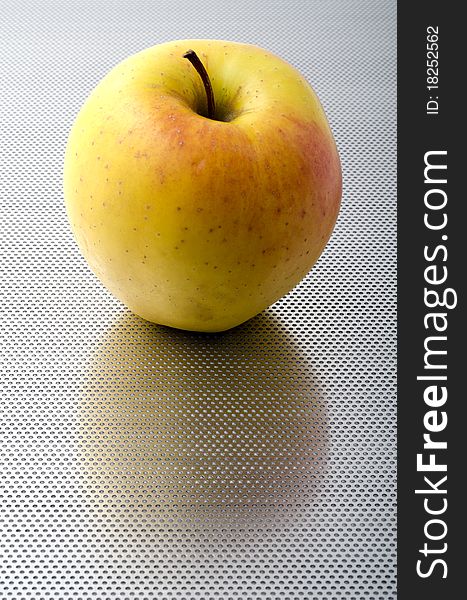 Apple on a perforated aluminum bottom