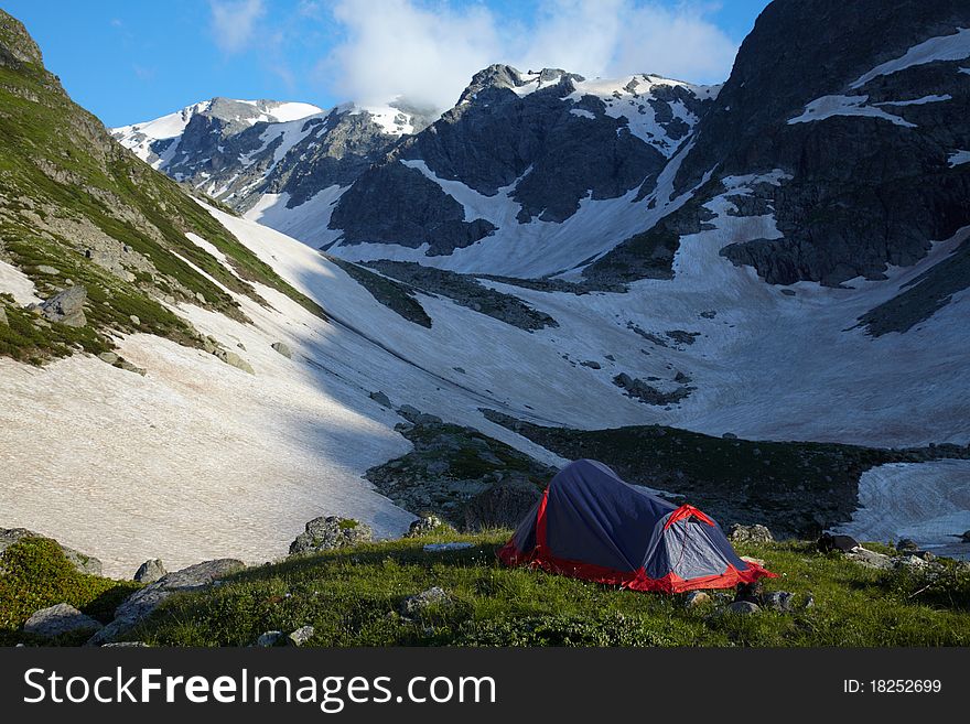 Tent on green grass in the high mountains. Tent on green grass in the high mountains
