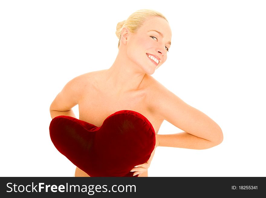 Naked woman with heart-shaped pillow in the white background