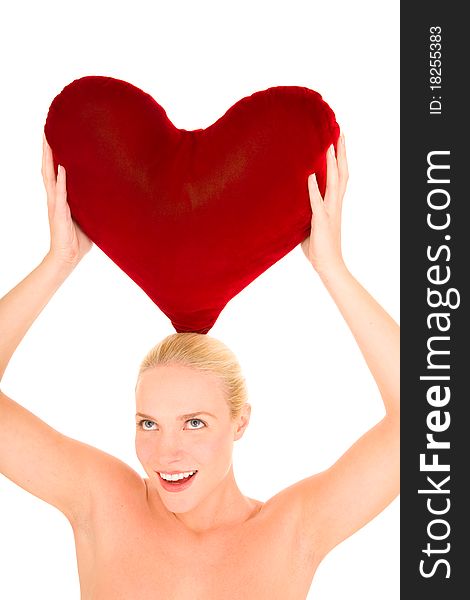 Naked woman with heart-shaped pillow in the white background