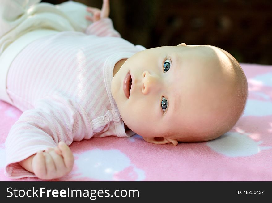 A portrait of little child is in pink tones