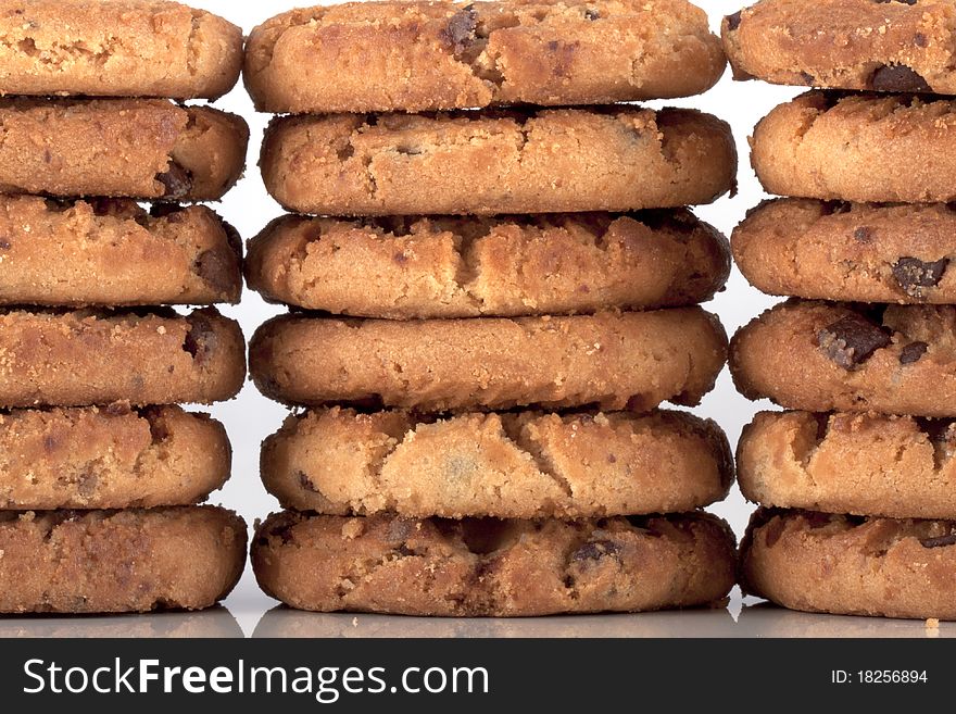 Pile of chocolate chip cookies, every cookie comes with a lot of chocolate chips, fresh baked just out of the oven isolated on white with copyspace