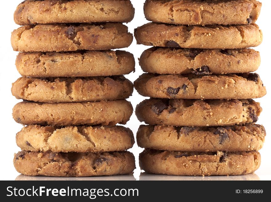 Pile of chocolate chip cookies, every cookie comes with a lot of chocolate chips, fresh baked just out of the oven isolated on white with copyspace