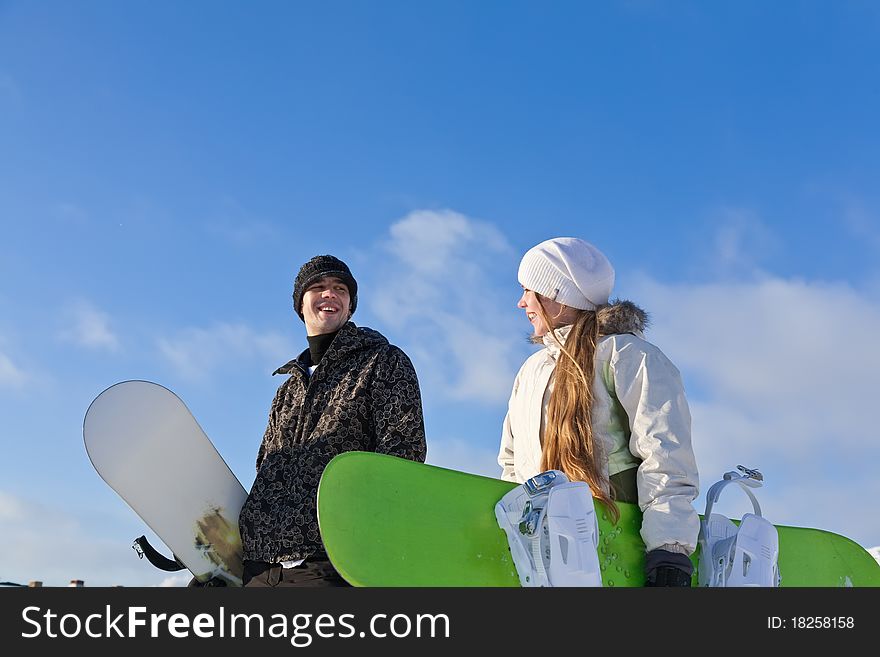 Young Smiling Couple With Snowboards