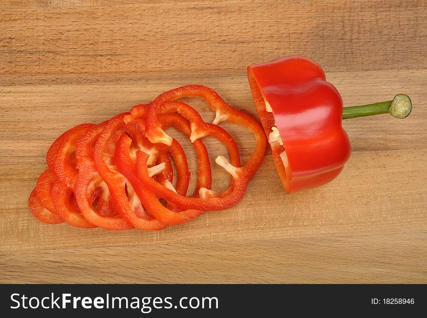 Red pepper sliced on a worn cutting board