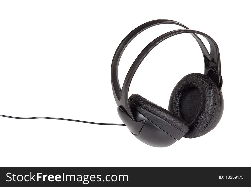 Big black headphones with the wire lying on a white background. Big black headphones with the wire lying on a white background