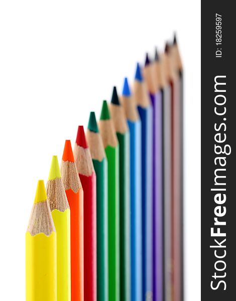 Colored pencils isolated on white background. Shallow depth of field