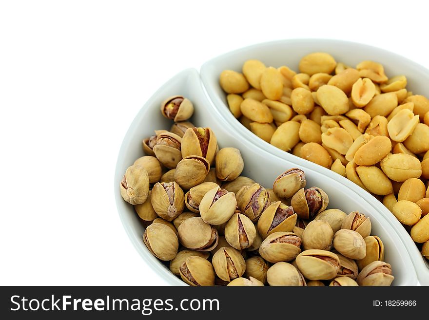 Fresh peanuts and pistachios. Isolated on white background