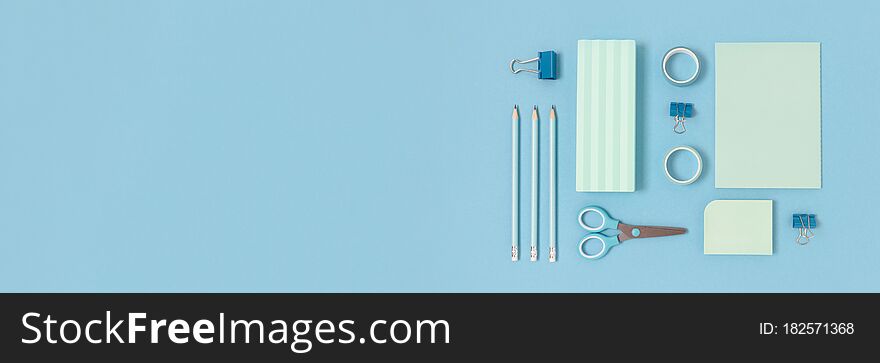 Layout of stationery on a blue pastel background. Monochrome school concept. Layout of stationery on a blue pastel background. Monochrome school concept
