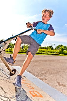 Boy With Scooter Stock Images