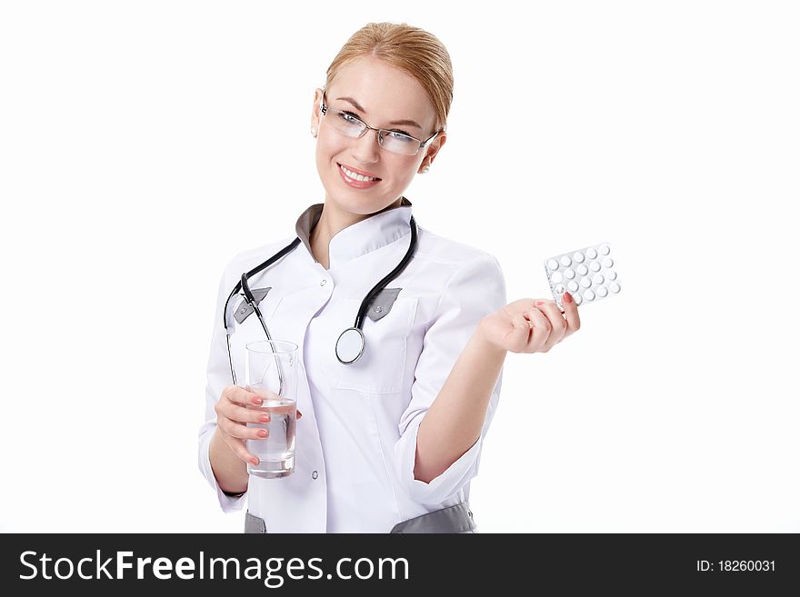 Young woman with stethoscope and pills on a white background. Young woman with stethoscope and pills on a white background
