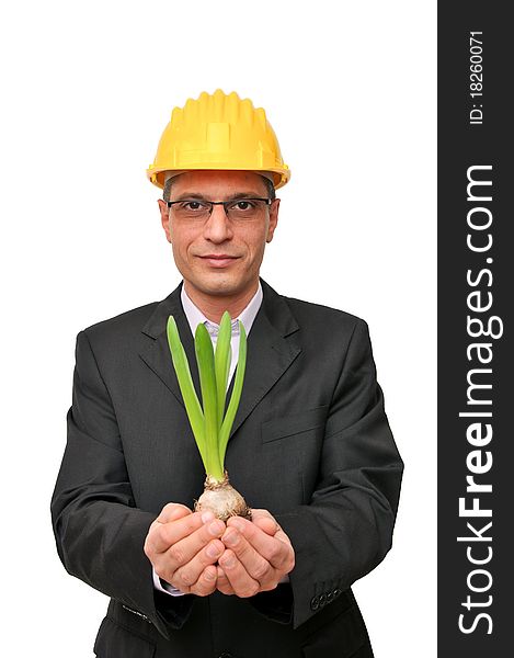 Engineer in suit holding protective small plant. Engineer in suit holding protective small plant