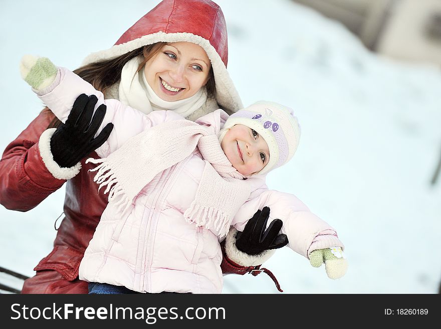 Young mother with her daughter. winter day. Young mother with her daughter. winter day