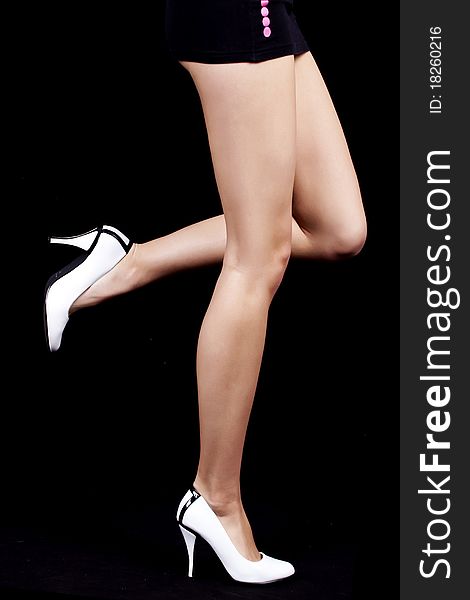 Close-up of the beautiful legs of a Women on black background. Close-up of the beautiful legs of a Women on black background