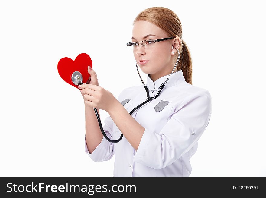 Young doctor listens to the heart on a white background. Young doctor listens to the heart on a white background