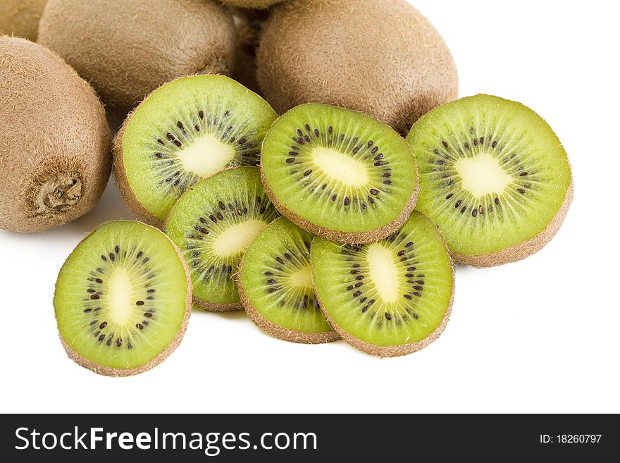 A few green fresh kiwi fruits, slices. A few green fresh kiwi fruits, slices