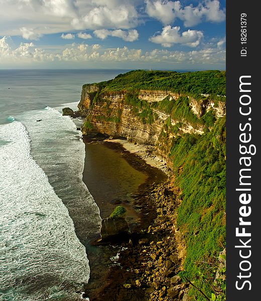 Bali green cliffs under cloudy sky near ocean