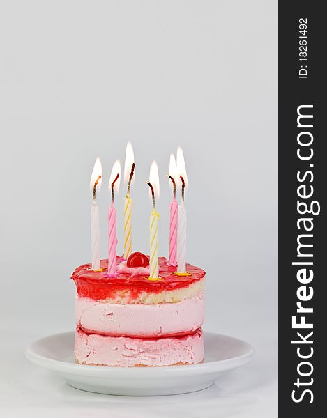 Cake with candle on wood table